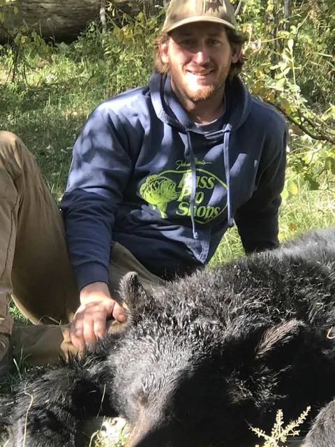 Hunter with a harvested black bear