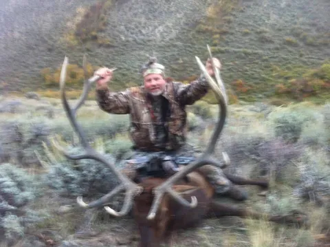 Hunter with a large bull elk