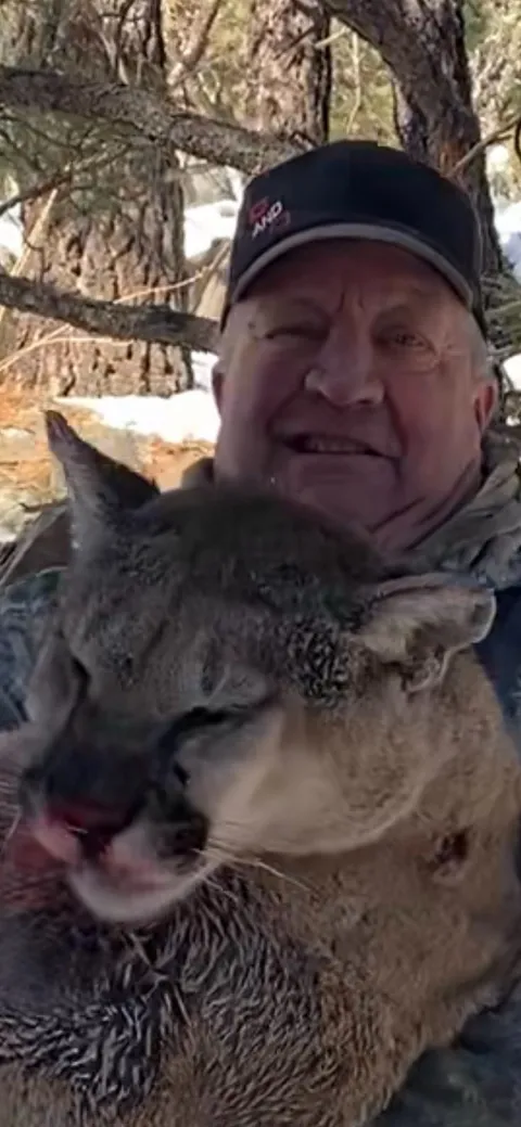 Hunter with a mountain lion, close-up